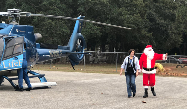Santa Visits School Christmas Party By Helicopter